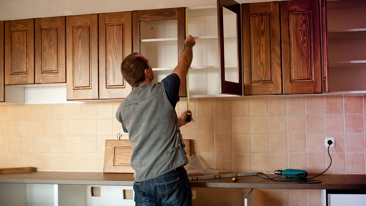 Person measuring cabinets