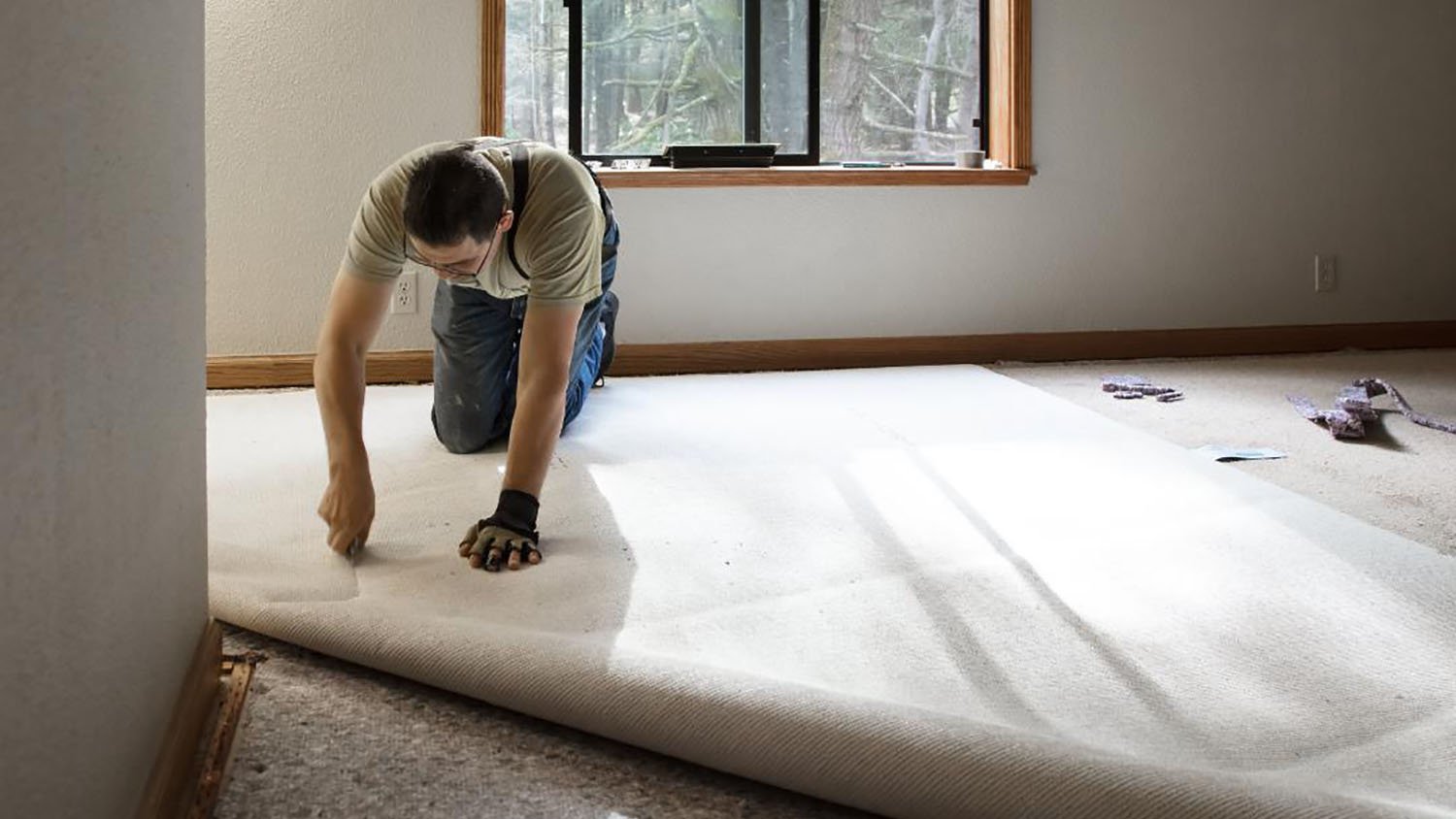 Person installing carpet