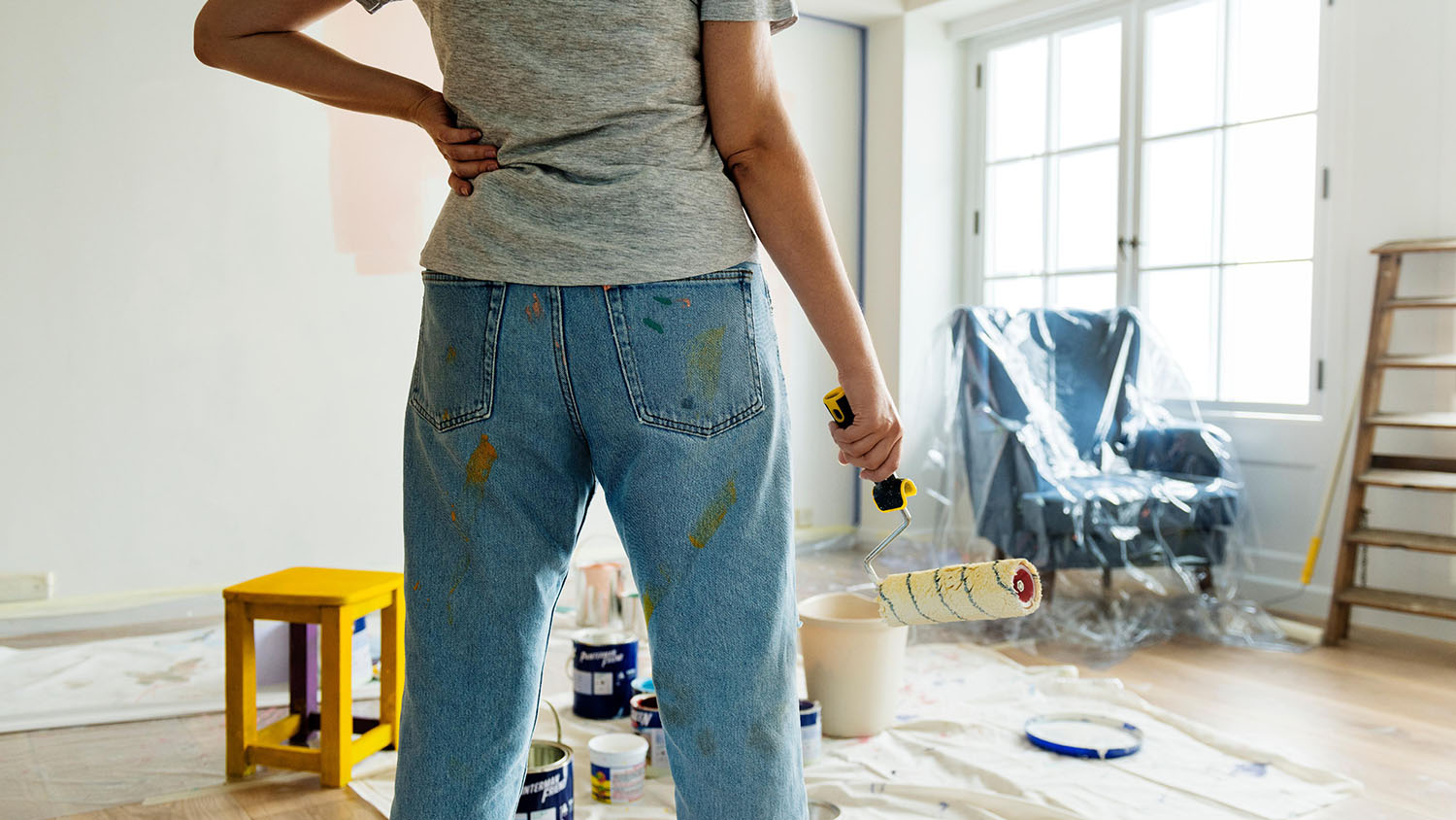 Person holding paint roller