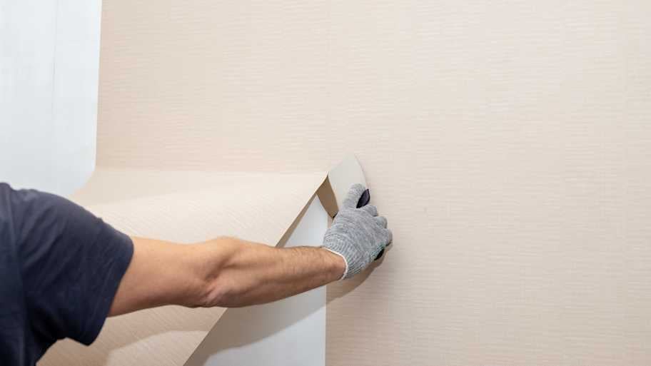 Worker removing wallpaper