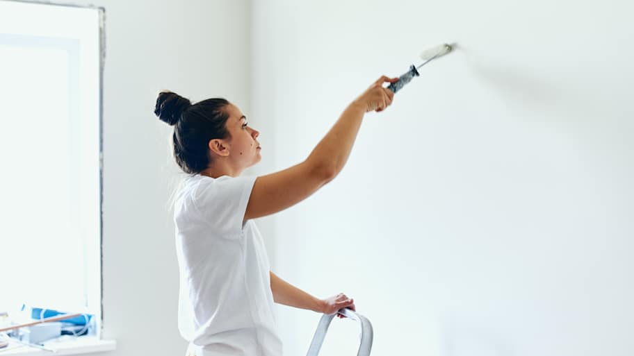 Woman painting wall