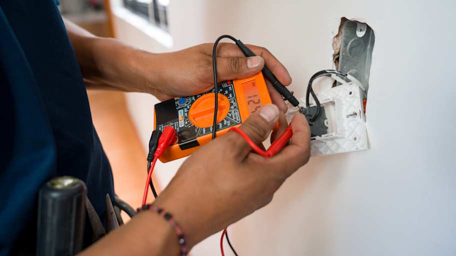 Electrician fixing an electrical outlet