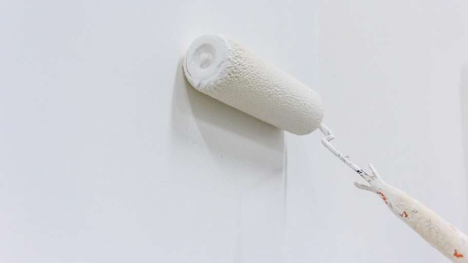 Painting a wall with paint roller