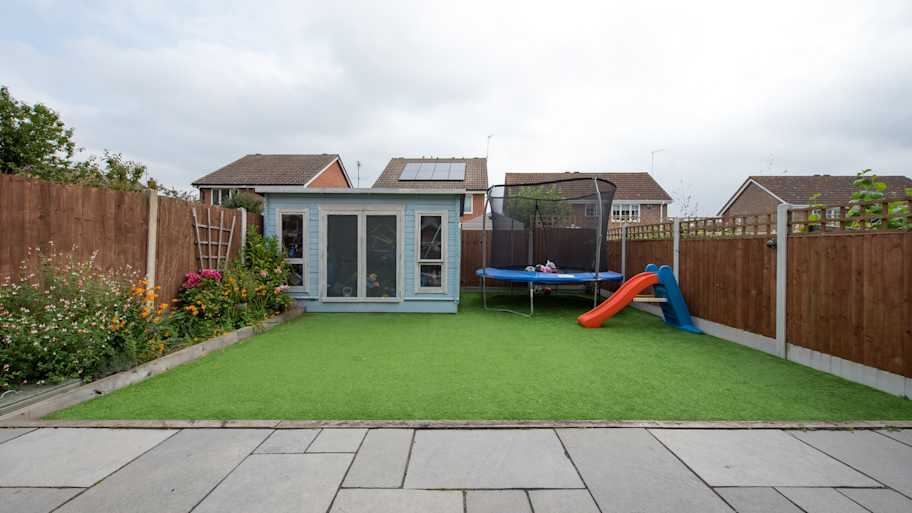 A general view of a back garden with artificial grass