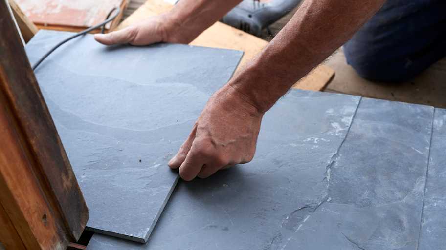 Worker holding a stone tile 