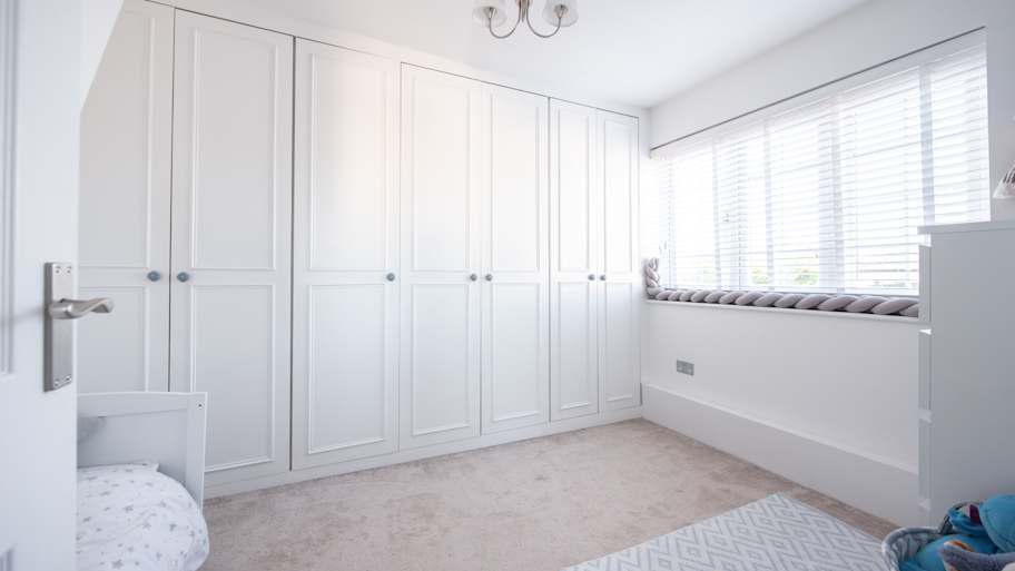 Bedroom with floor to ceiling wardrobes