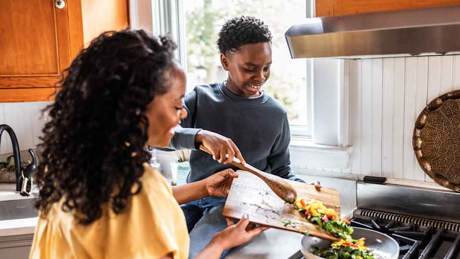 Mother and young son cooking together