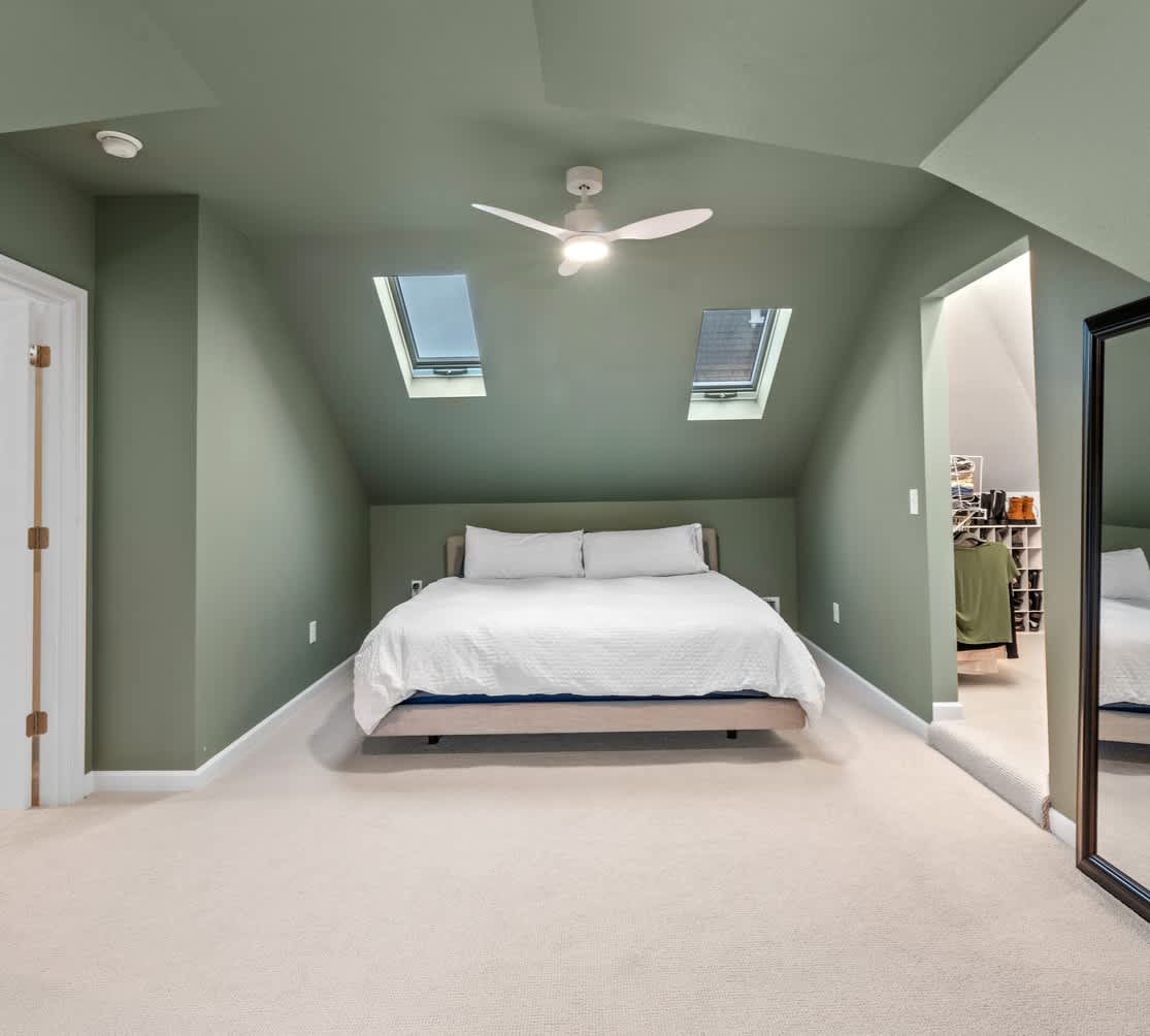 clean bedroom with green wall paint