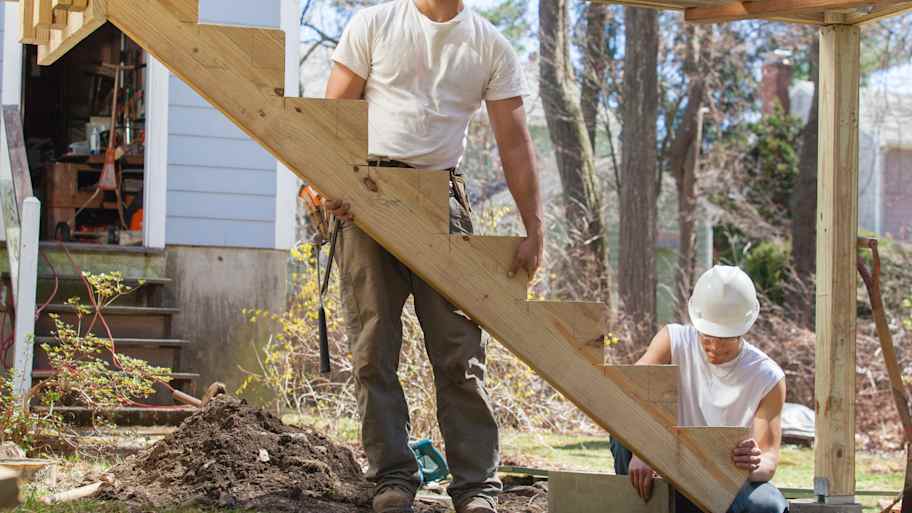 Carpenters installing stair stringer