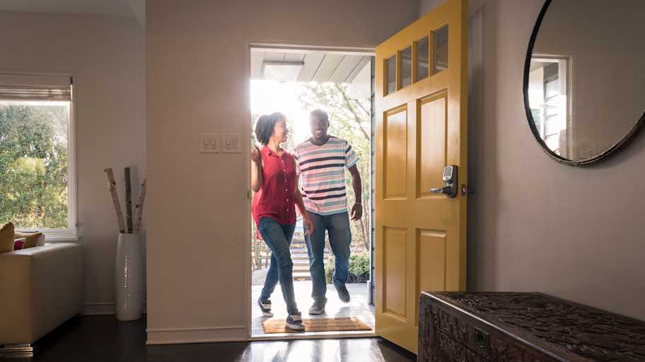 Young man and woman stepping into the house