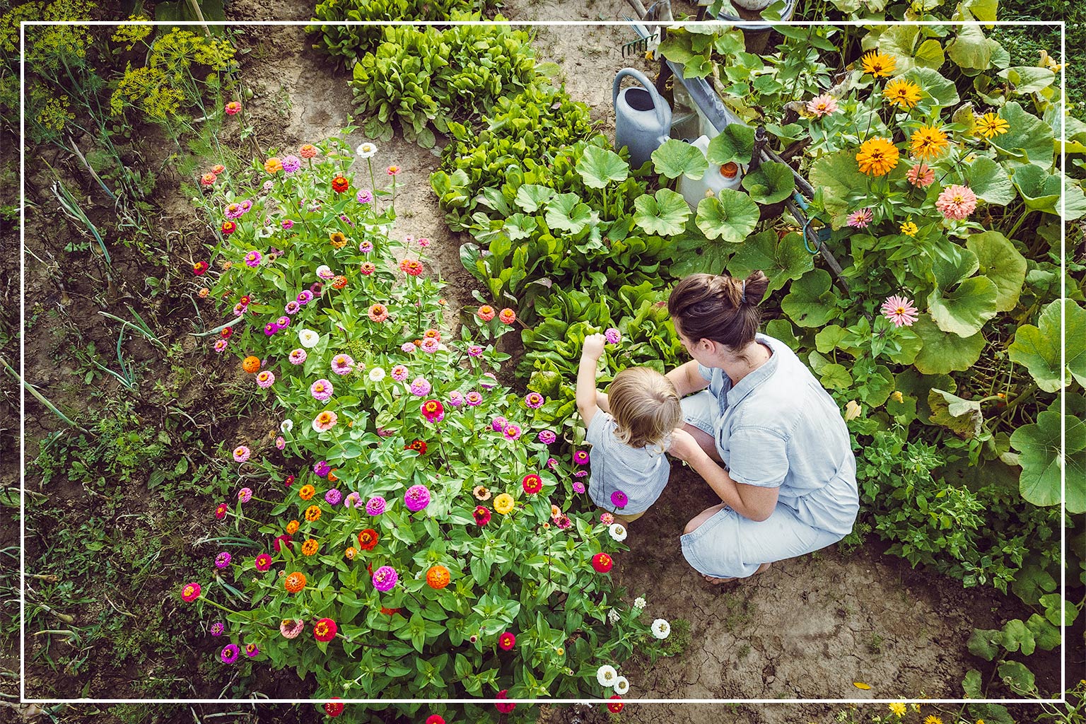 mother and child planting native flowers