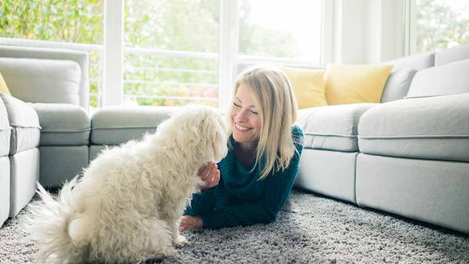 woman on the carpet with dog