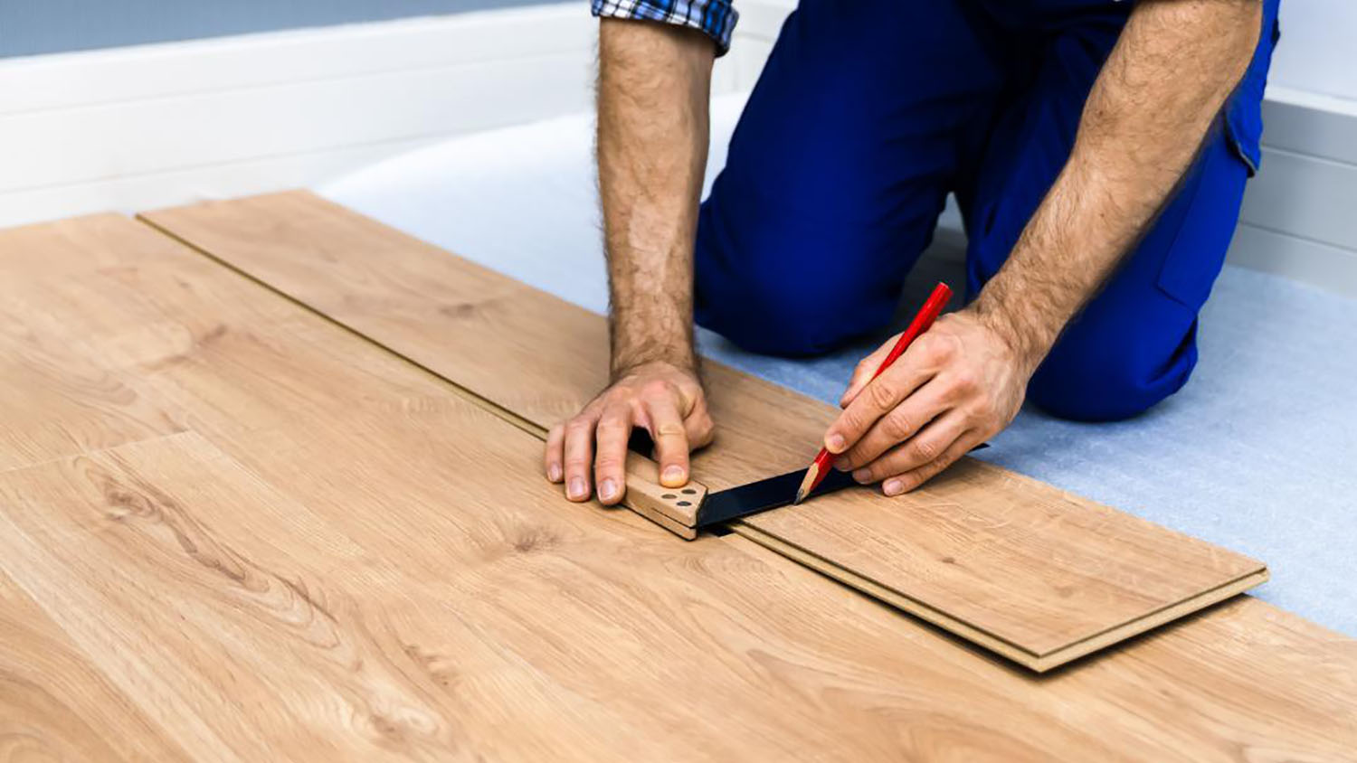 Person cutting floorboards