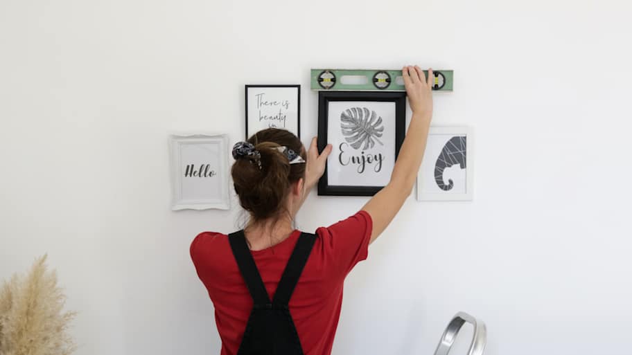 Woman using a level on frame 