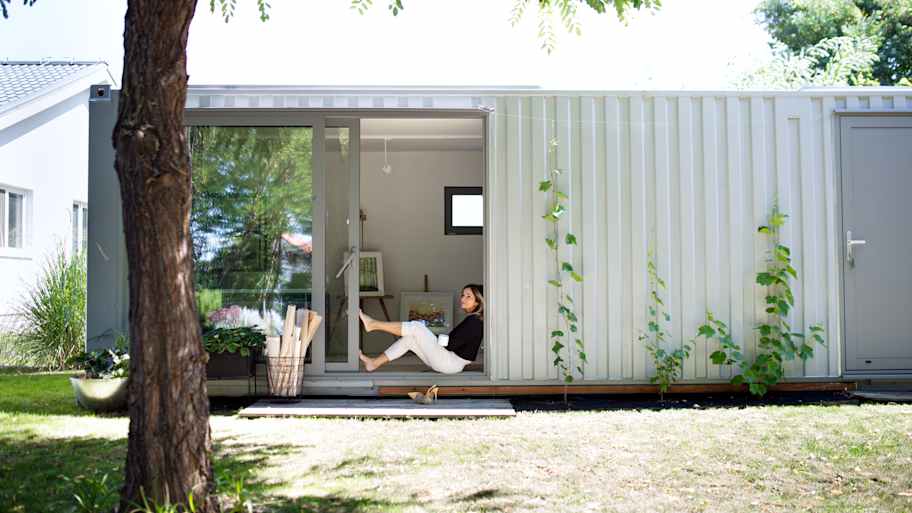 Woman sitting outside container home