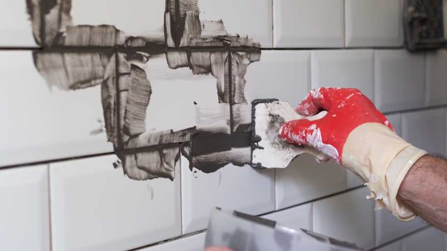 Worker grouting tiles 
