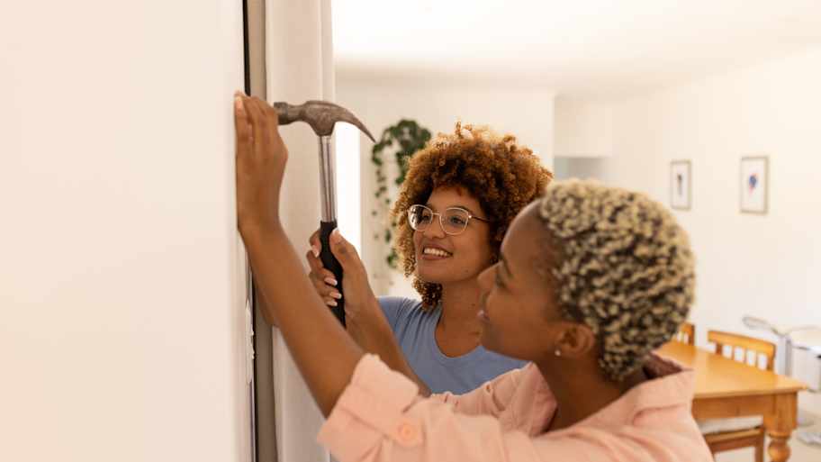 Woman nailing picture frame