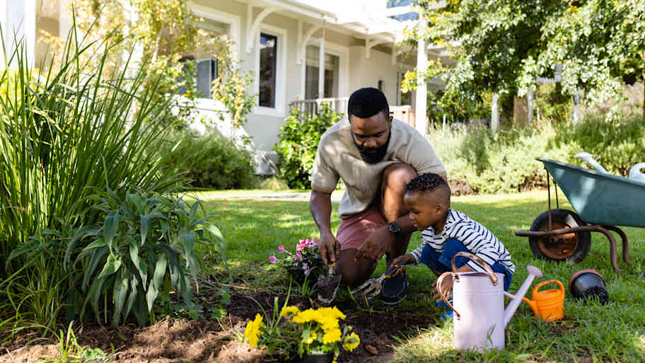 father and son gardening in yard