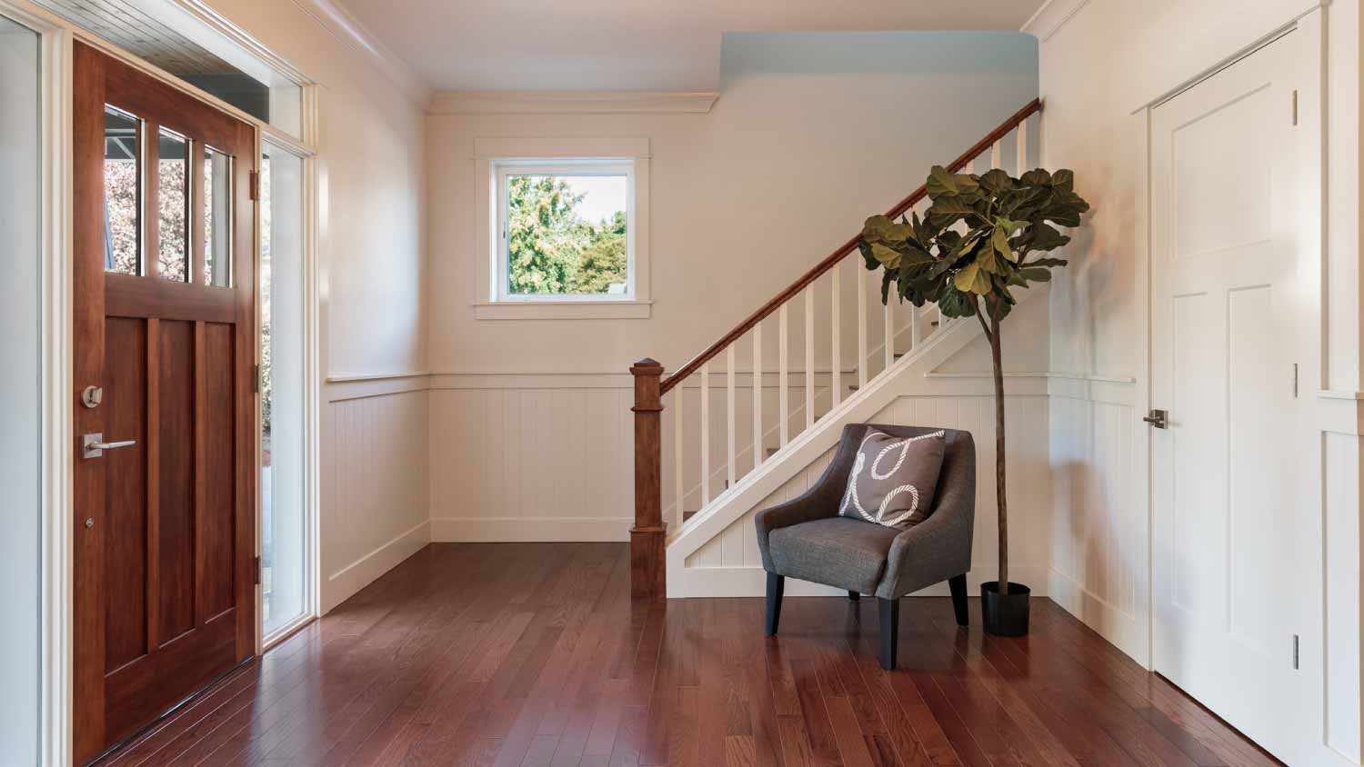 Armchair and tree in house entryway