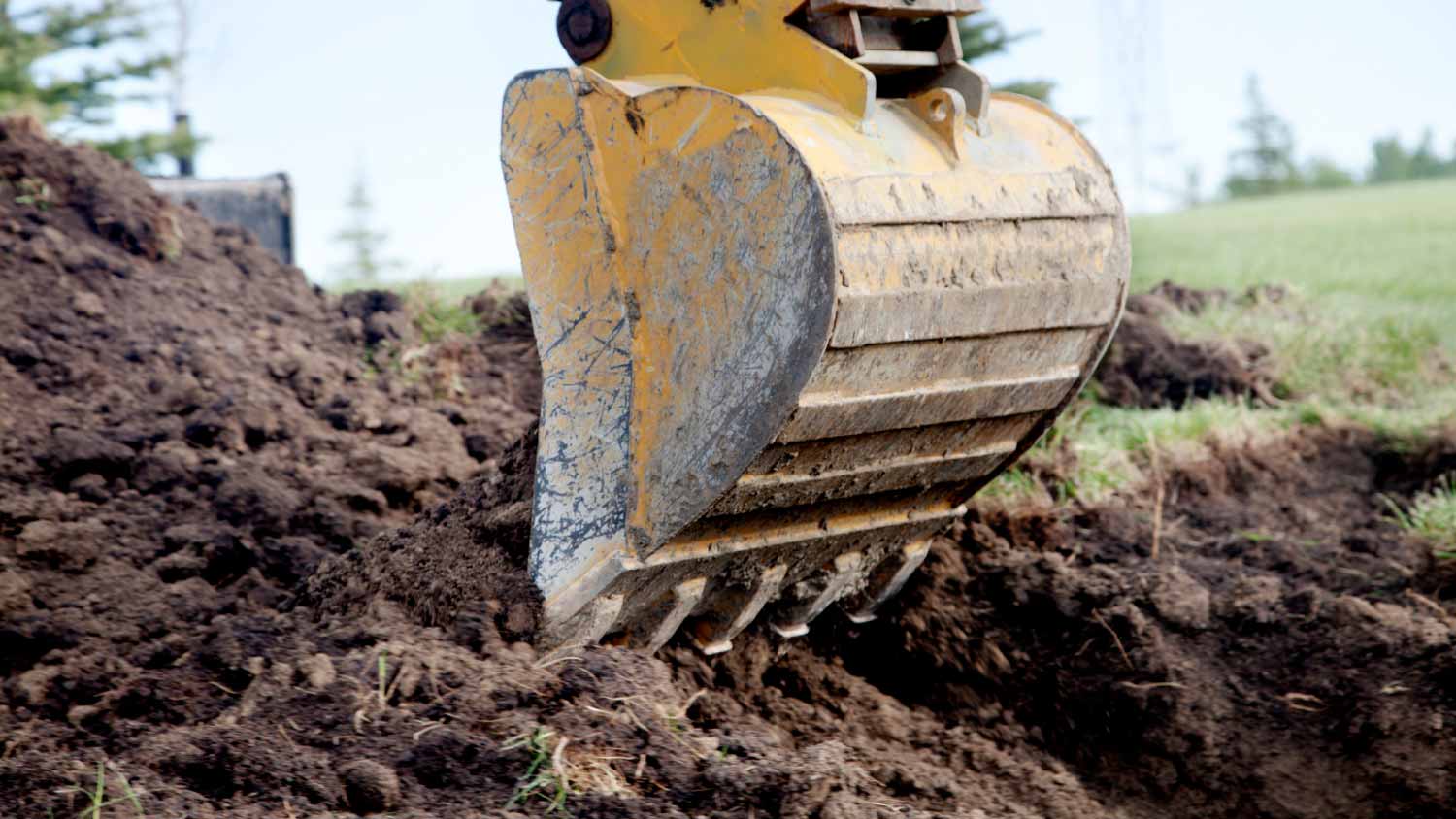 Backhoe digging a trench