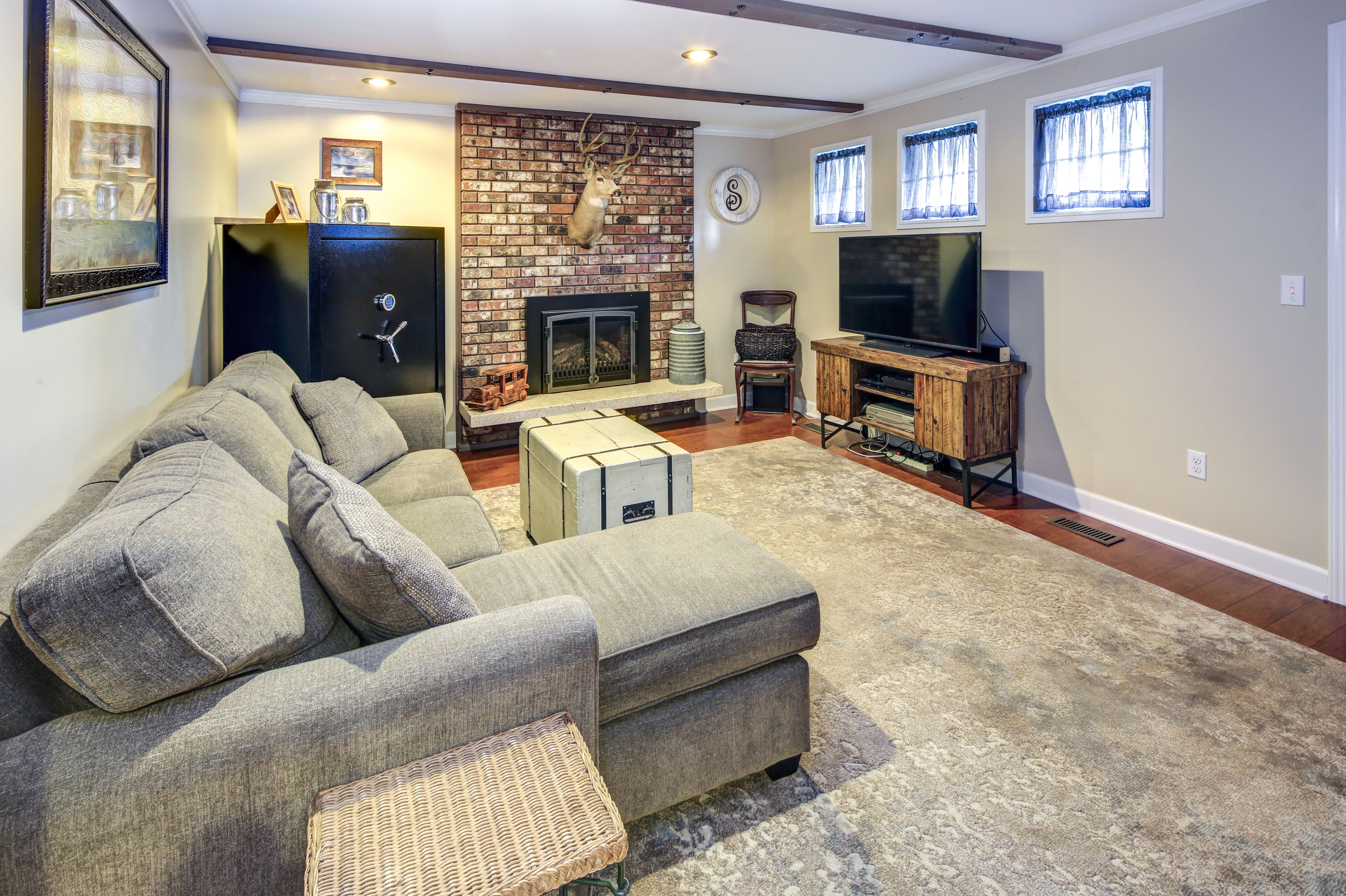 A basement living space with faux exposed wood beams