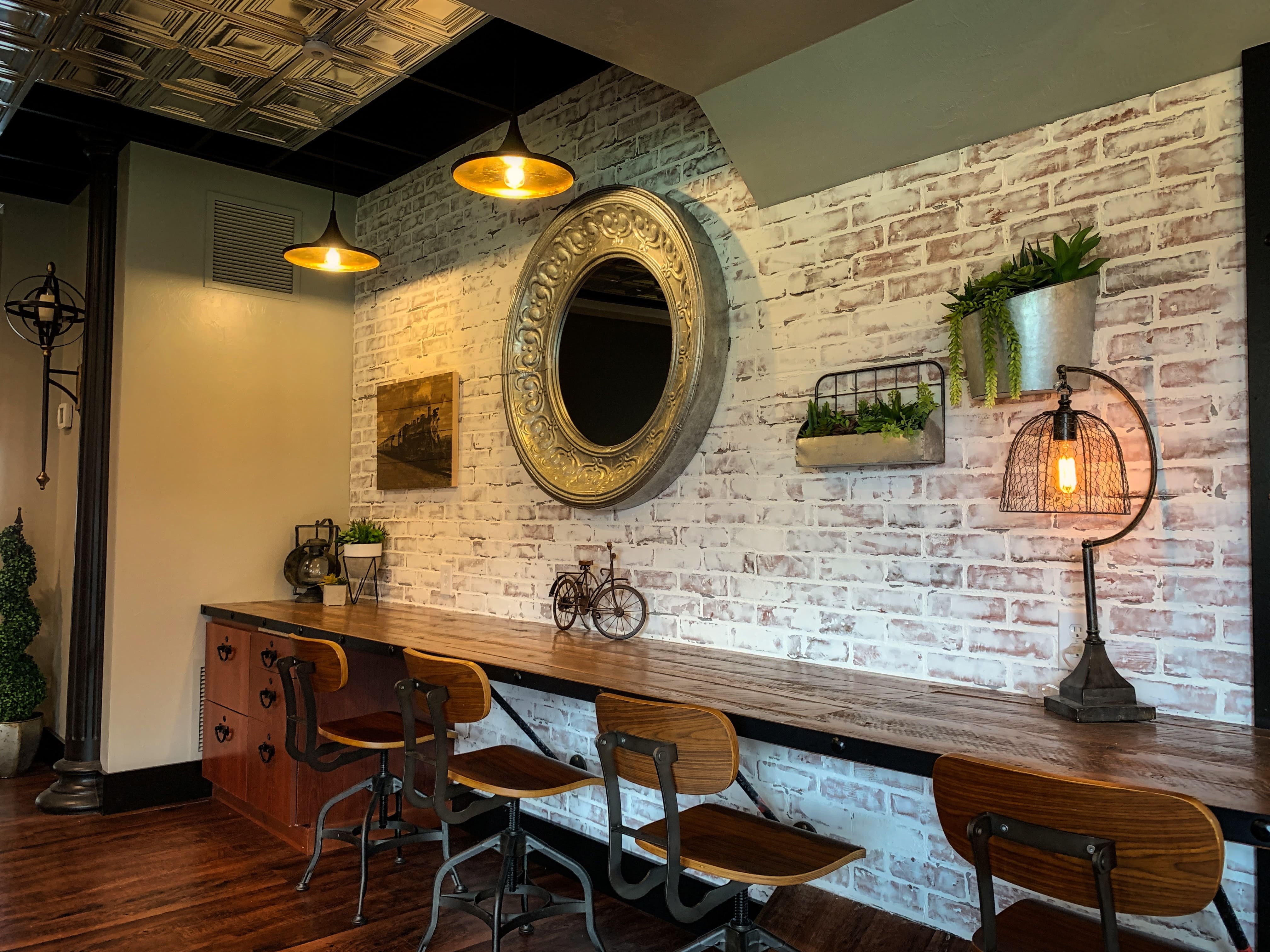 A basement with exposed brick and a tin ceiling