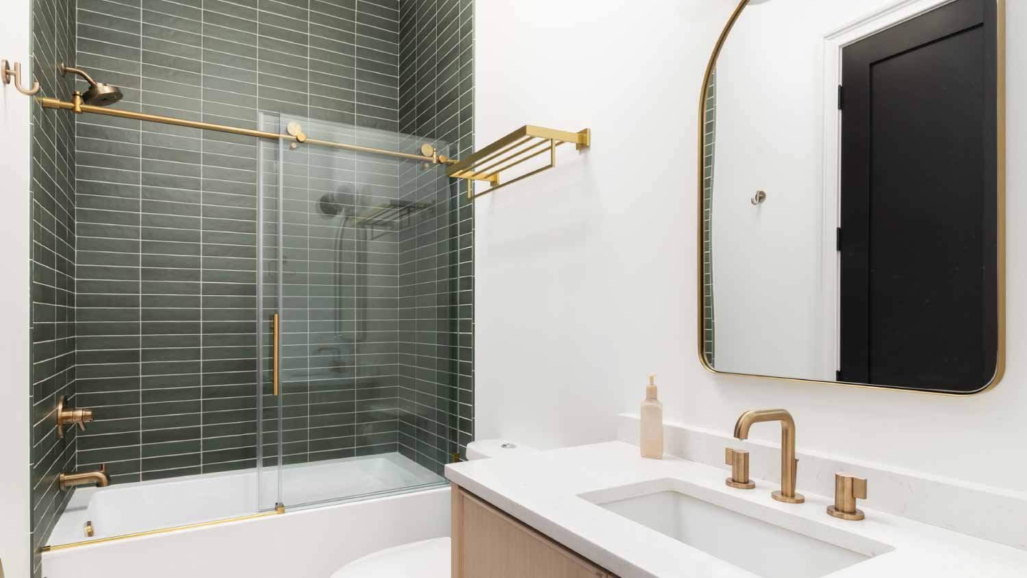 Bathroom with green subway tiles