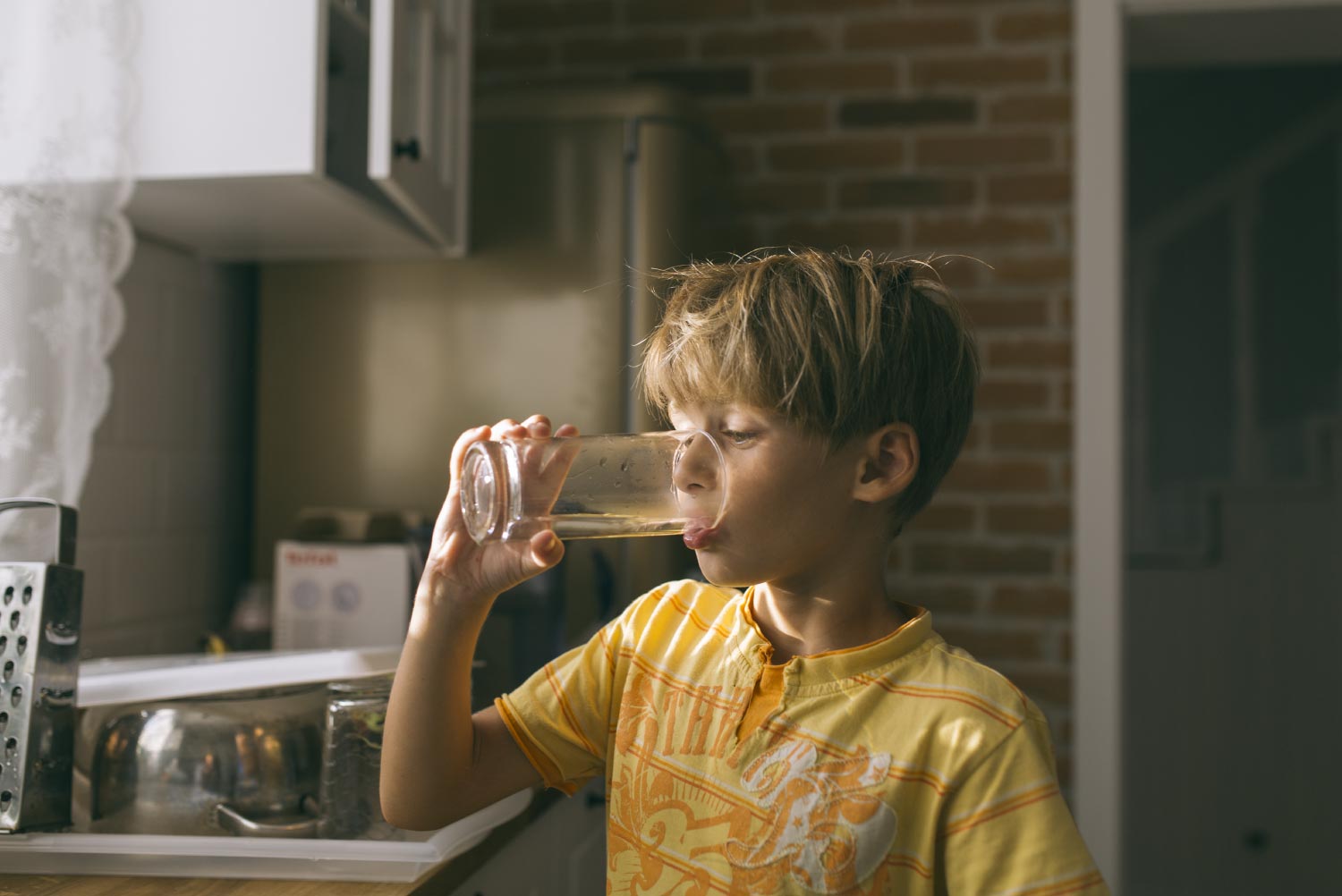 A boy drinking tap water