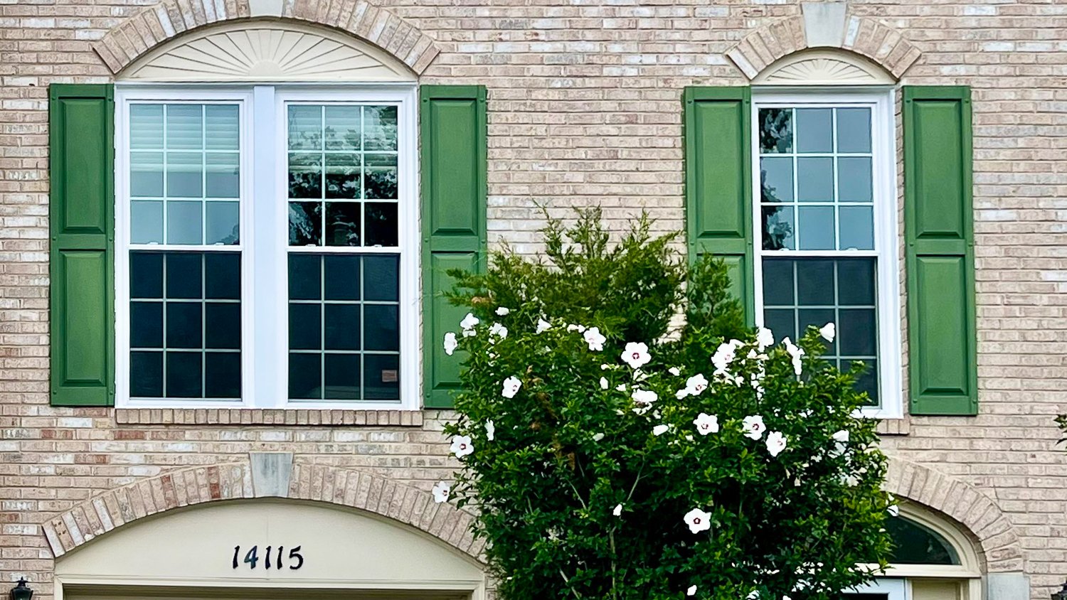 Brick house with green shutters