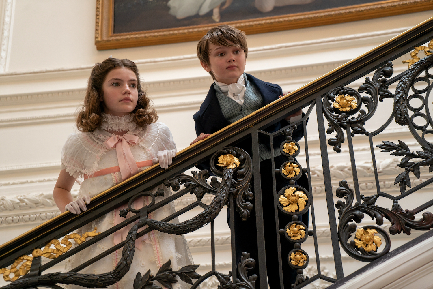 Two Regency era children standing on staircase