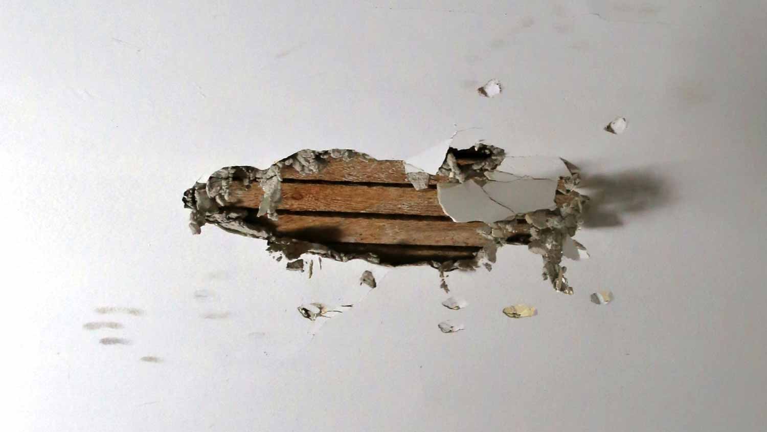 Broken drywall on a interior ceiling
