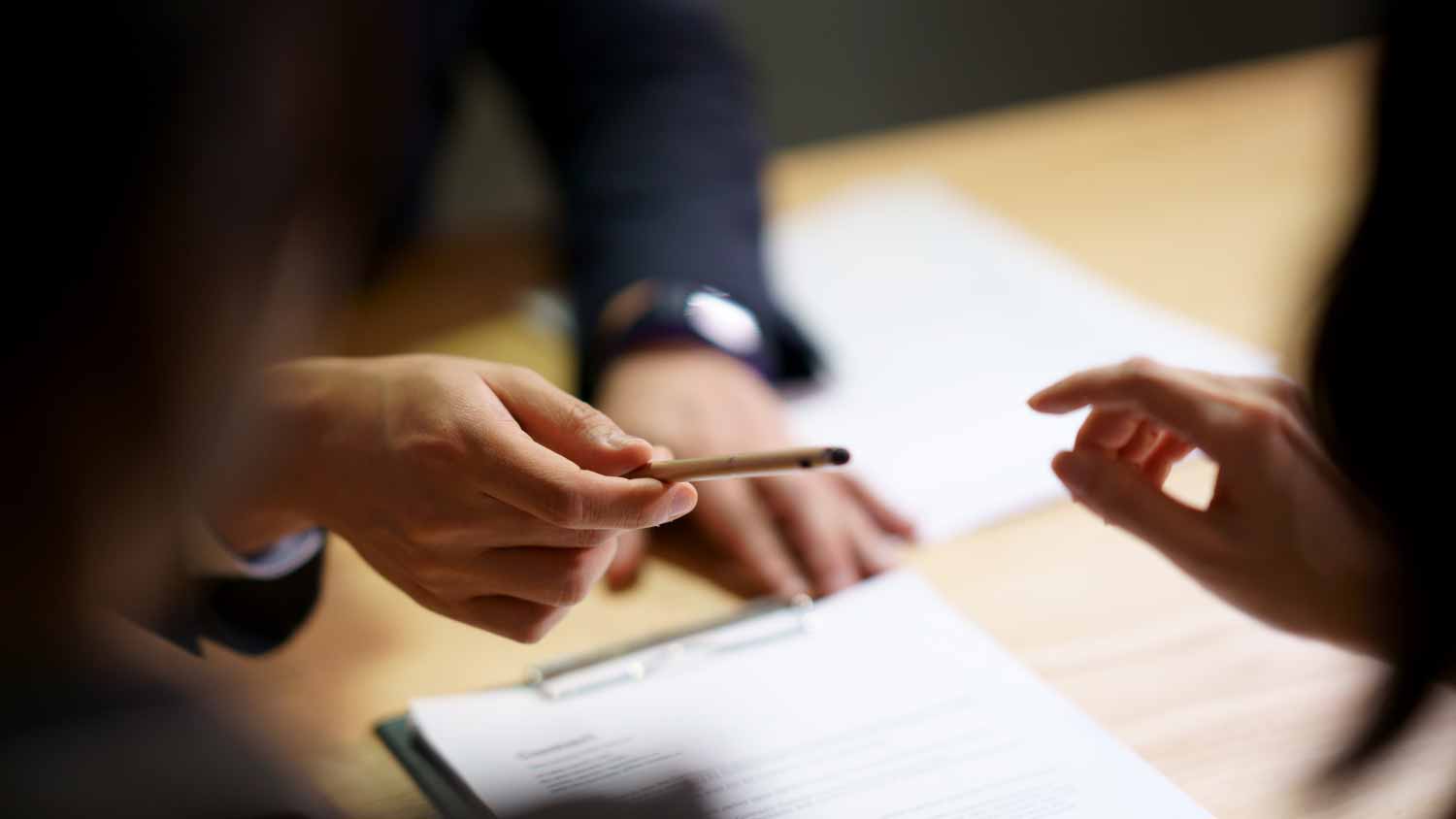 Businessman giving pen to partnership