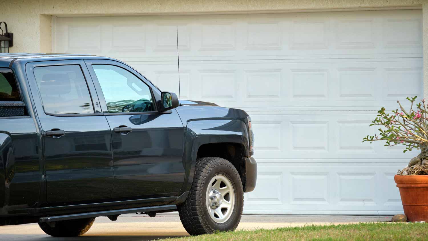 Car parked in front of wide garage