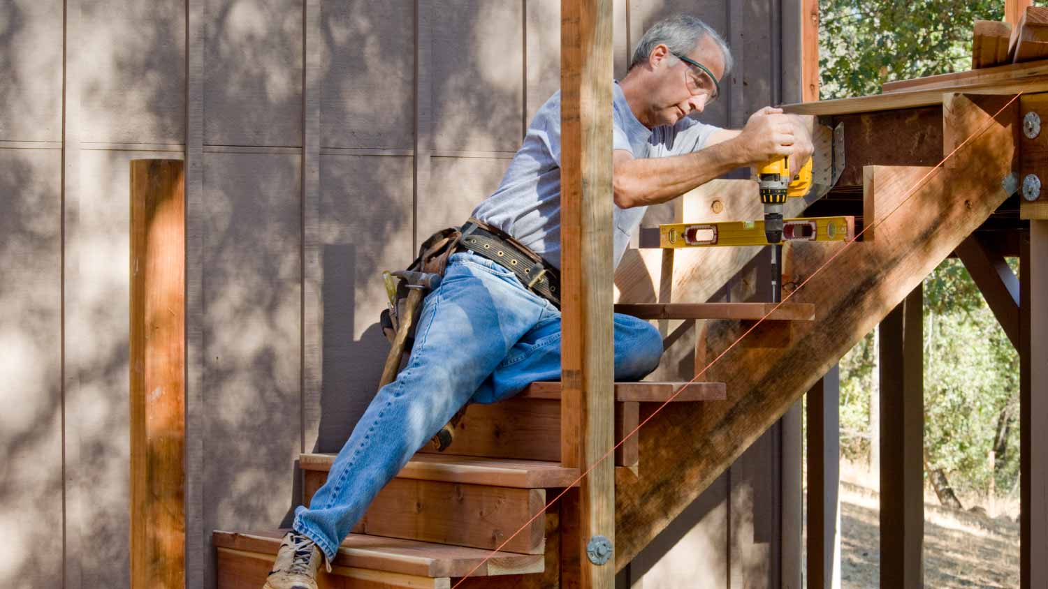 Carpenter installing deck stairs