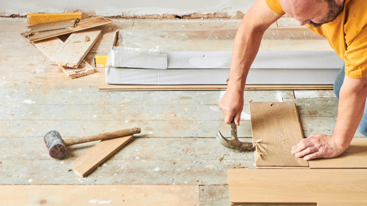 A carpenter laying new wood