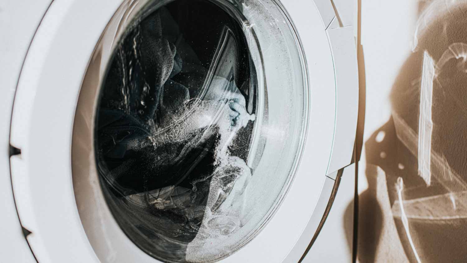 A close up of a washing machine running a load of laundry