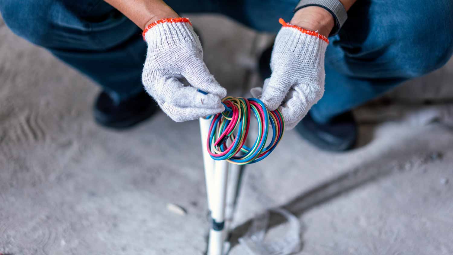 Construction worker repairing electric wire