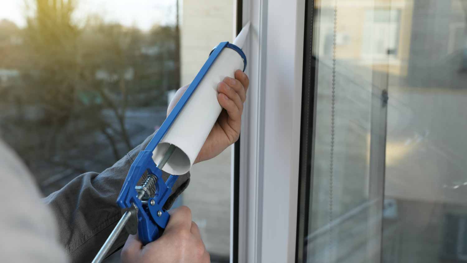 Construction worker sealing window