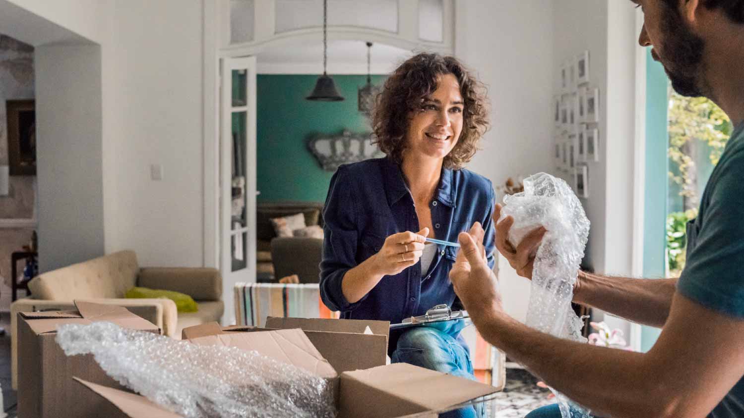 Couple packing cardboard boxes