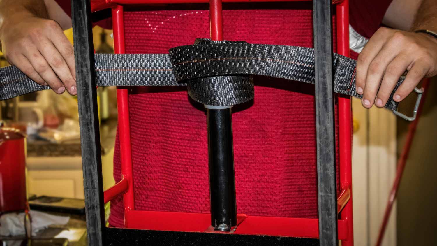 Delivery man adjusts straps on heavy duty Steel