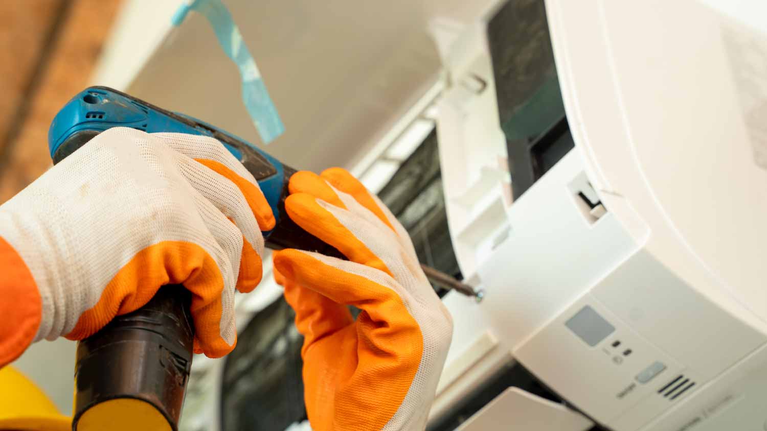 Electrician installing air conditioner