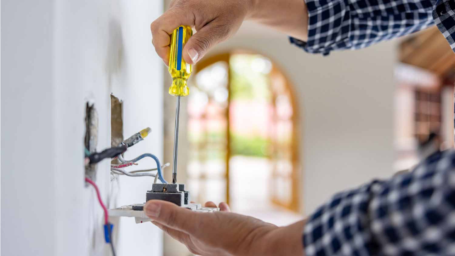 Electrician installing a power outlet