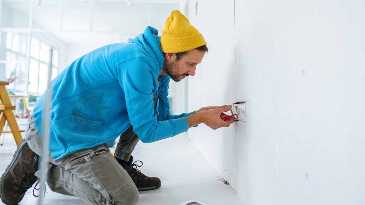 Electrician installing a power socket 
