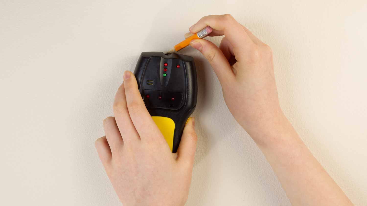 Electrician using stud finder