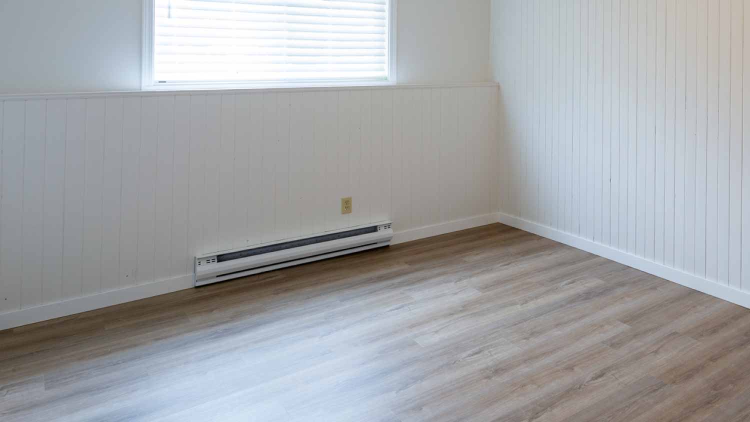 Empty room with a baseboard heater