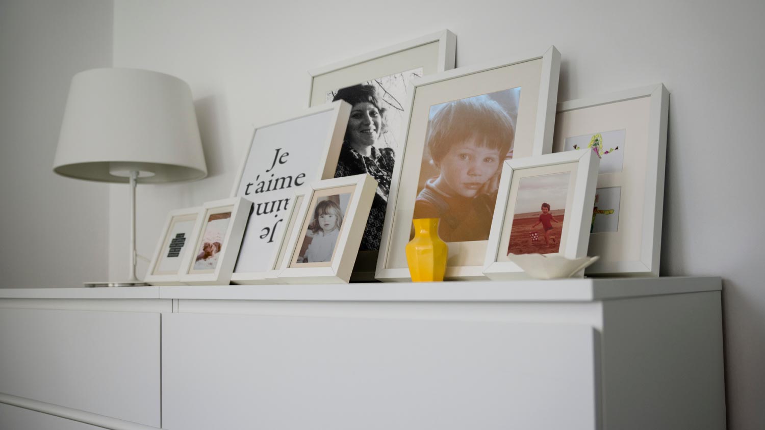 Family photographs displayed on cabinet