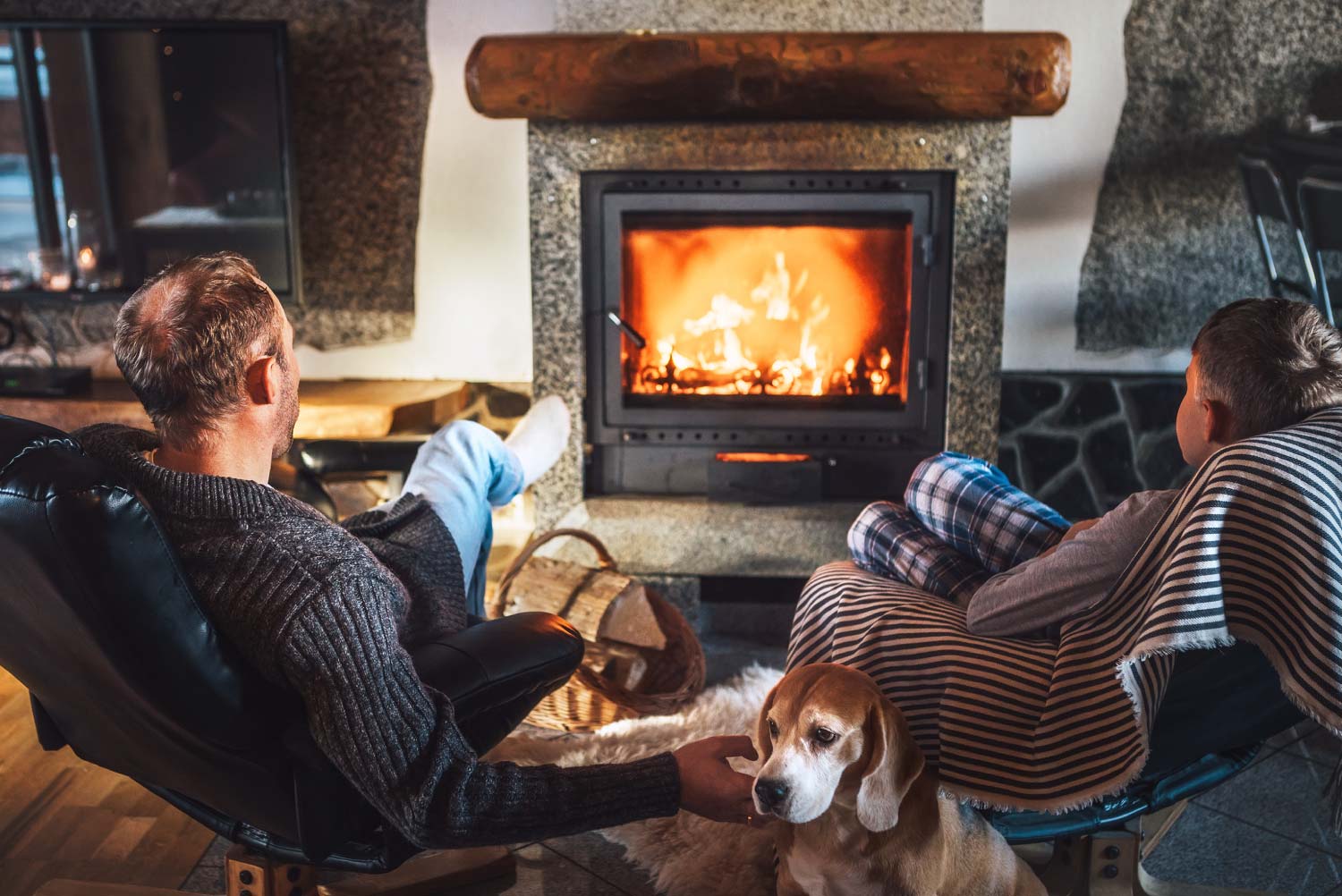 Father with son sitting near fireplace