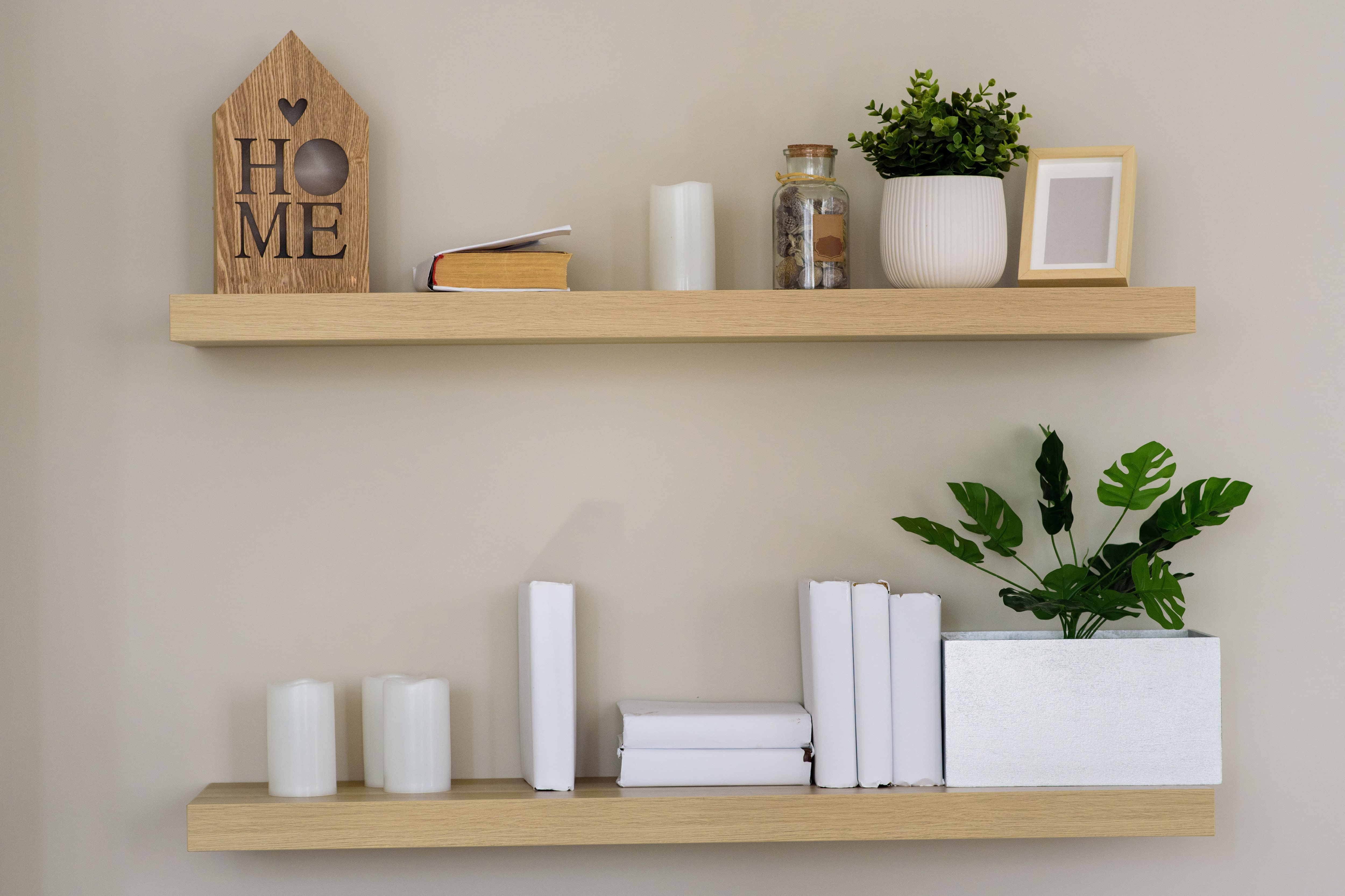 Wooden floating shelves with minimalist decor on top