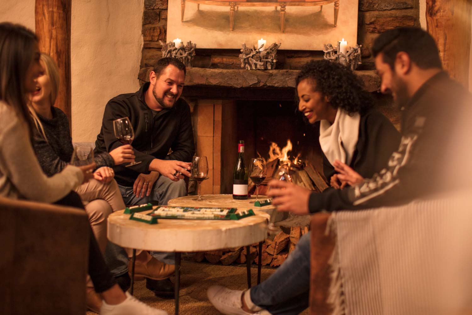 Friends sitting together at table playing a game