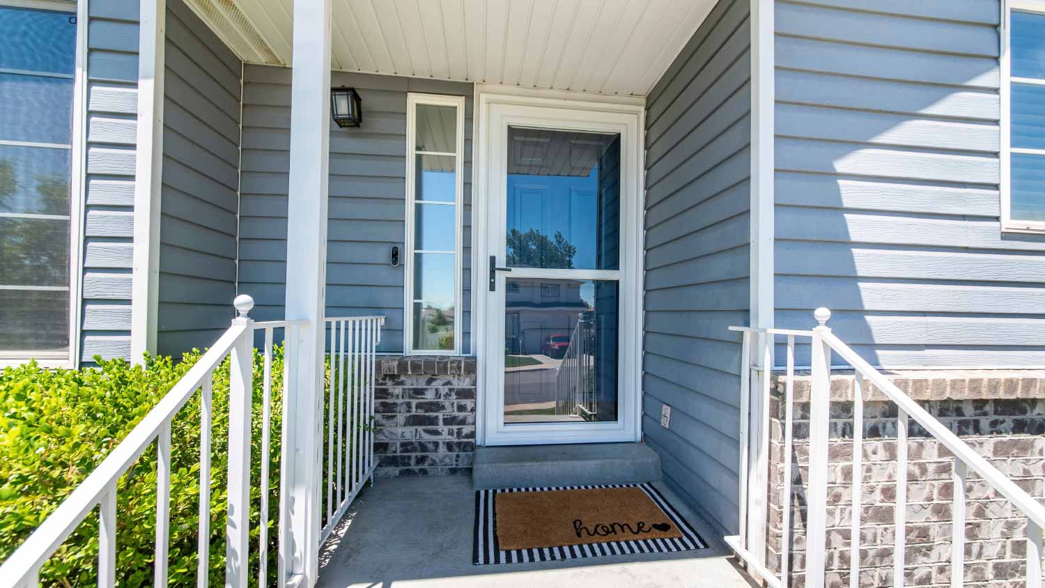 Front porch of a house with glass storm door